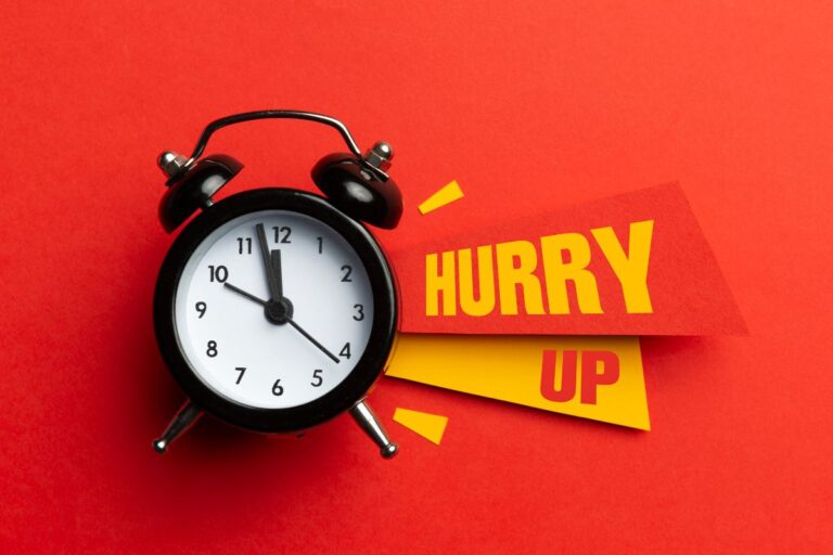 old timey alarm clock with sign that says hurry up