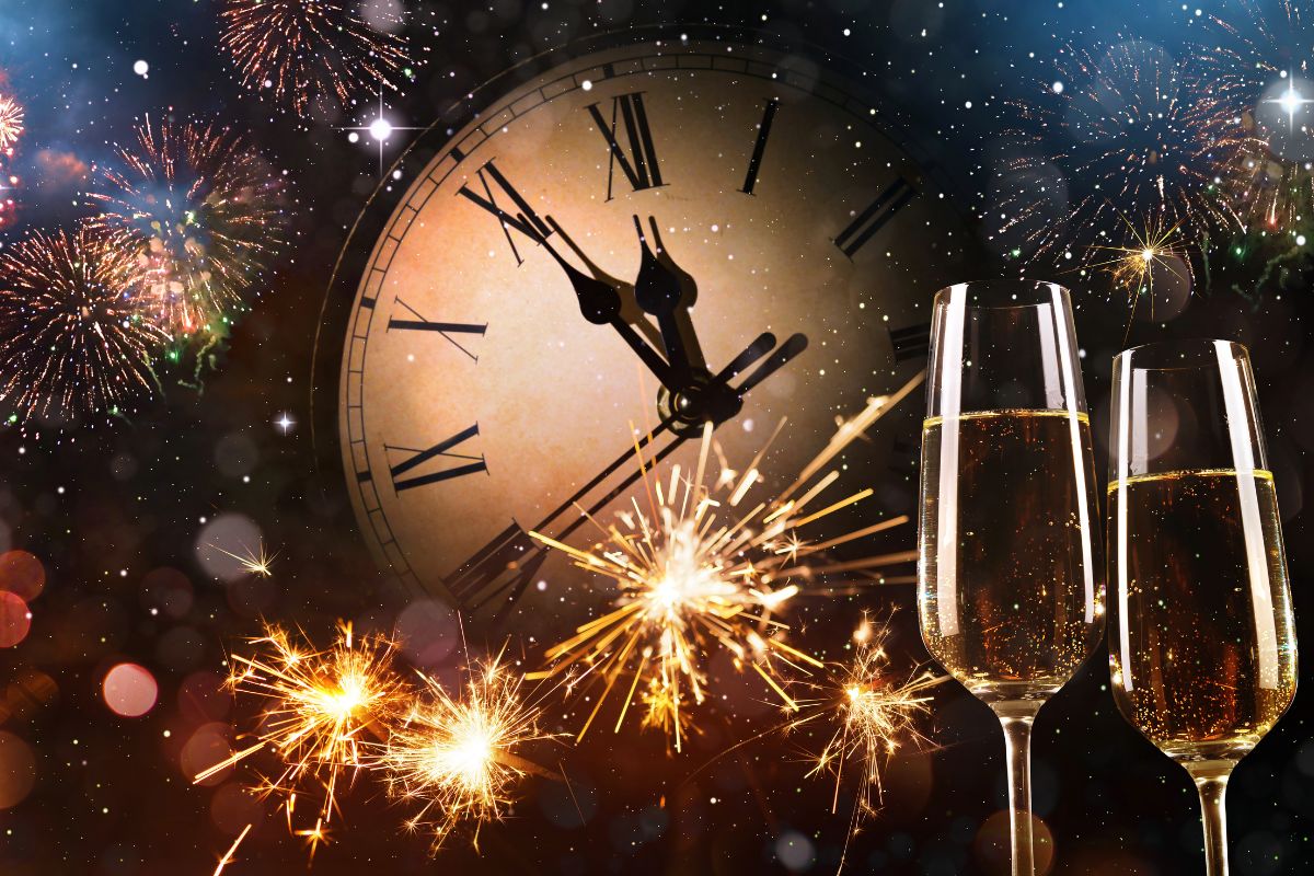 new year celebration with clock fireworks and champagne glasses